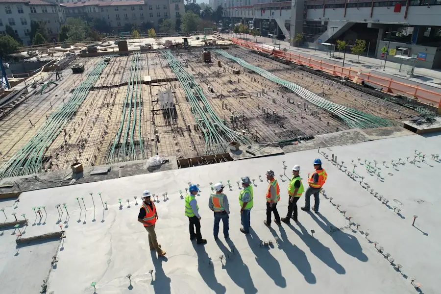 Construction crew in hard hats and safety vests on a large site